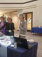 LLI/NOVA Volunteer June Chalou talking with visitors to the LLI/NOVA exhibit at the NoVA Positive Aging and Wellness Fair LLI/NOVA Volunteer June Chalou talking with visitors to the LLI/NOVA exhibit at the NoVA Positive Aging and Wellness Fair